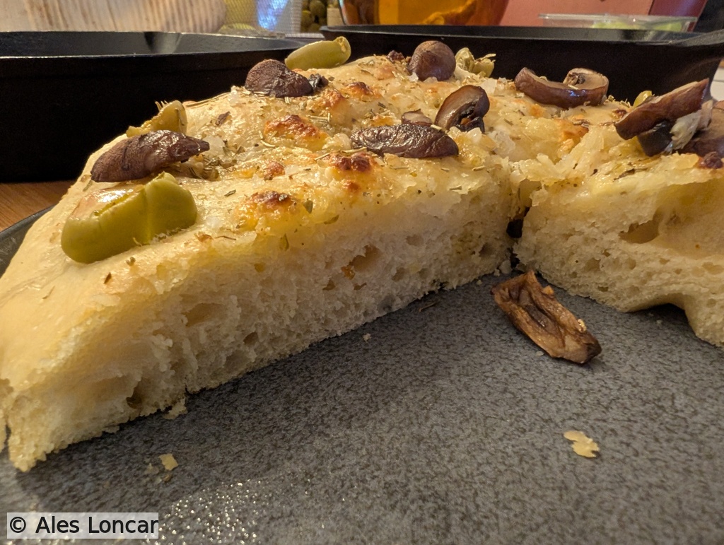 Side profile view of a fresh slice. You can see the structure held up beautifully under the weight of the toppings.