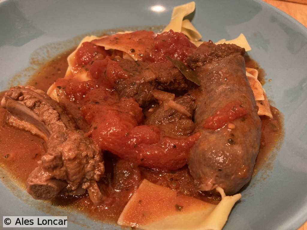 Version one: Pure comfort food. Homemade noodles buried under a deeply savory tomato ragu featuring slow-cooked ribs and sausages. This is what Sundays are made for.
