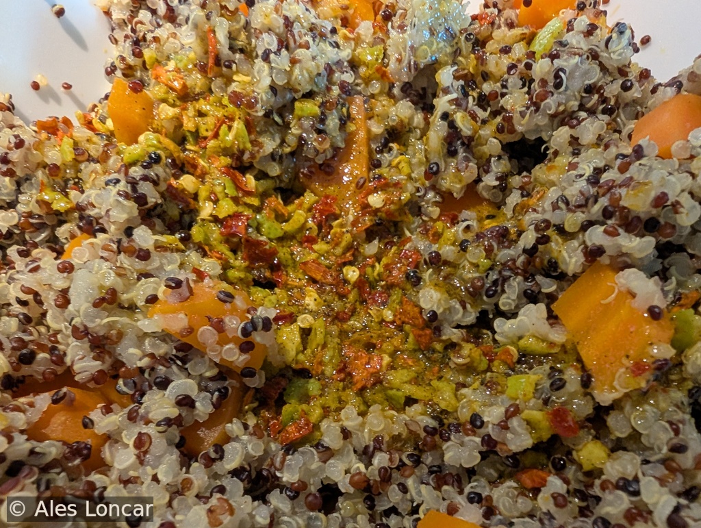 Where the magic happens. Pouring a zesty dressing of fresh chili, lime juice, mint, and a touch of curry powder over warm quinoa and sweet carrots. The grains soak up all that brightness instantly.